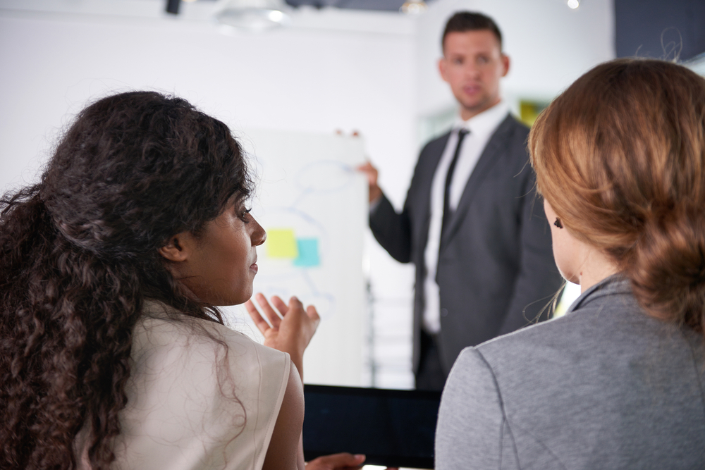 team of successful business people having a meeting in executive sunlit office